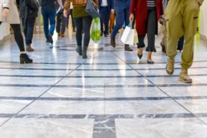 "Agoraphobia" - a crowd of feet walking away and toward the camera in a mall setting.