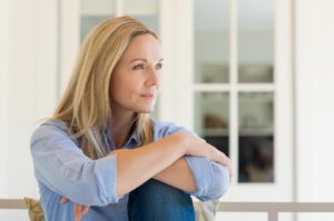 "Health anxiety (Hypochondriasis)". A relaxed woman leans her arms on her knees, looking away.