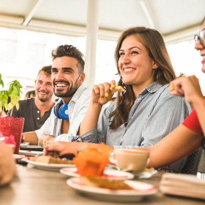 "Treatment of Borderline Personality Disorder". A group of friends enjoying a meal together, a young woman feeling comfortable and able to manage.