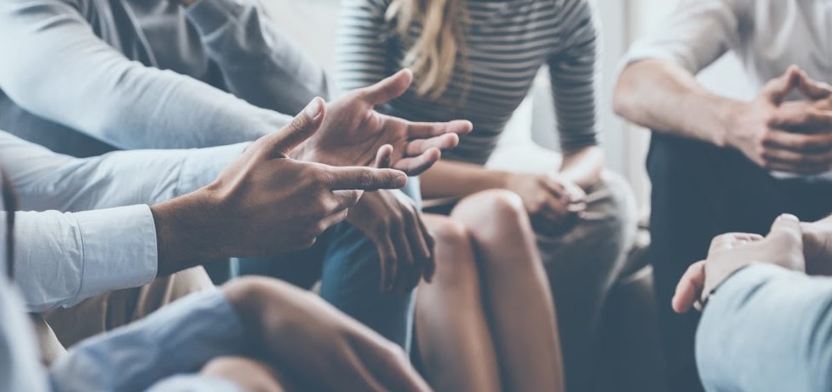 A person gestures during a group therapy session.