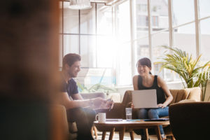 "Supervised practice". A therapist and supervised practice therapist share a smile while sitting in a comfortable room, ready to work.